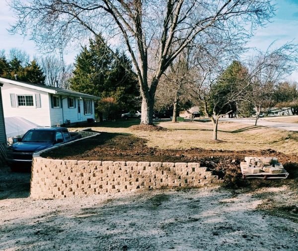 Our retaining walls are started by leveling the ground area & compacting the soil for a solid base.